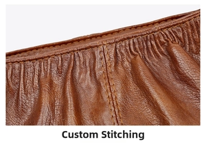 Detailed macro view of the exquisite double stitching on the brown ruched leather handbag