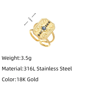 Macro detail of 316L stainless steel gold ring with evil eye pattern and black crystals