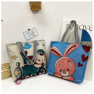 Detail of thick canvas tote bags with cartoon bear and rabbit prints and striped handles