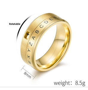 Detail of 8mm rotatable gold titanium ring featuring etched A-Z letters and smooth finish