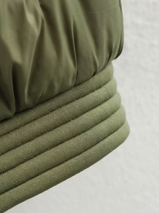 Detailaufnahme der olivgrünen Jacke mit Rippstrickbündchen und hochwertigem Polyamid-Gewebe