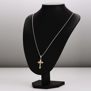 Two-tone gold and silver crucifix necklace displayed on a black neck mannequin