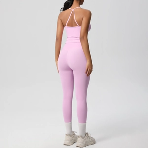 Detail of pink-purple yoga set featuring criss-cross back straps and high-waist leggings