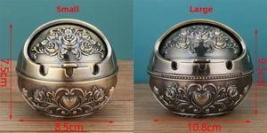 Detail view comparing small and large vintage metal ashtrays with rose relief patterns