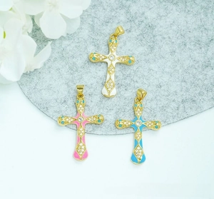 Macro shot of 18K gold plated cross pendants with enamel colors and micro zircon