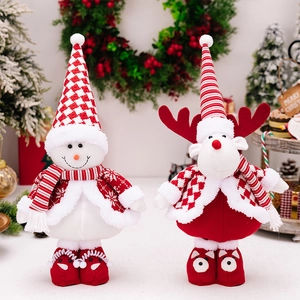 Detail of Christmas snowman and reindeer plush dolls with festive snowflake patterns