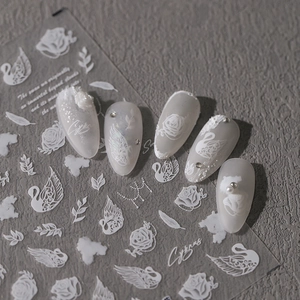 3D embossed nail art stickers with white swans, roses and feathers on matte nails