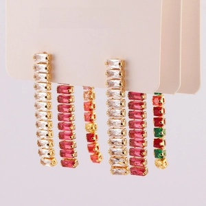 Macro detail of dangling rectangular crystal earrings with zircon long tassel design