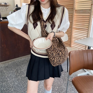 Chic leopard print canvas crossbody bag paired with a beige knit vest and skirt