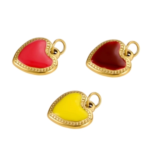 Close-up of heart-shaped pendants in red, burgundy and yellow with gold-plated frames