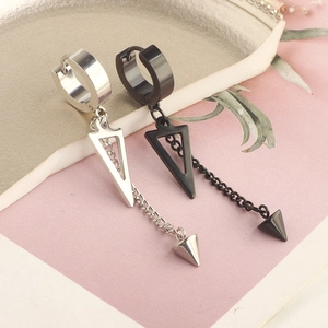 Punk style stainless steel cone drop earrings in silver and black on a textured backdrop