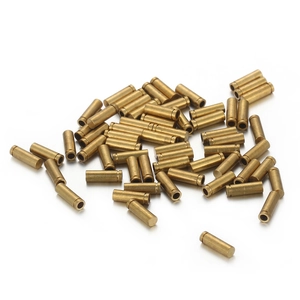 Precision cylindrical brass hardware components with grooved details on white background