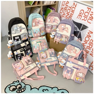Detailed view of canvas backpacks in pastel colors with cute plush pendants and multi-pockets