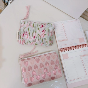 Detail of floral tulip and pink heart pattern jacquard coin pouches with zipper pulls