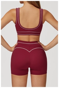 Back view of burgundy high-waist yoga shorts set with contrast piping details