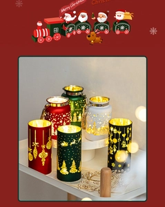 Detail of Christmas tea light holders with festive reindeer and tree patterns in warm LED light