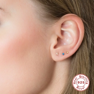 S925 sterling silver ear stud set with flower, blue opal, and gold beads in human ear wear
