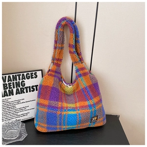 Close-up of colorful checkered plush tote bag made of soft sherpa wool on a table
