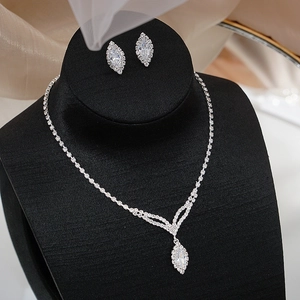 Macro detail of silver bridal jewelry set with marquise-cut cubic zirconia tassels