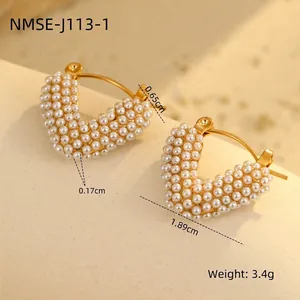 Macro shot of 18K gold heart-shaped hoop earrings with inlaid white pearls and dimensions