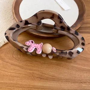 Vintage leopard acrylic hair claw clip with pink puppy design and rhinestones