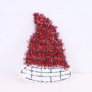 Detail of Santa hat Christmas ornament made from red and white tinsel on a mesh frame