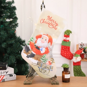Detail of beige Christmas stocking with Santa Claus print and Merry Christmas text