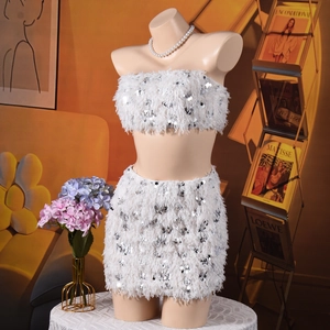 Close-up of white sequin texture and feather trim on two-piece crop top and skirt set