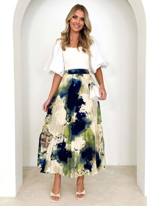 Detail of high-waisted pleated skirt with abstract oil painting print and fluid texture