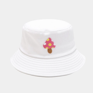 Detailed close-up of pink mushroom embroidery on a white cotton bucket hat with parallel stitching