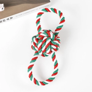 Detail of red, green, and white woven cotton rope toy with sturdy knot for dogs