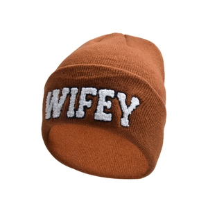 Detailed view of the brown knitted beanie with white chenille WIFEY embroidery texture