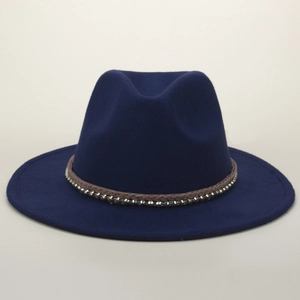 Macro shot of navy wool fedora with brown braided band and silver metal stud details