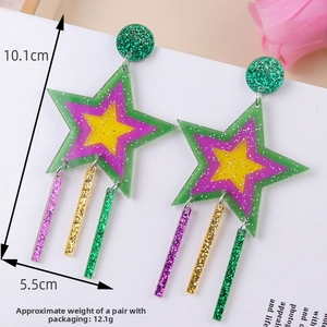 Macro detail of large 10.1cm Y2K acrylic star earrings with colorful glitter and tassels