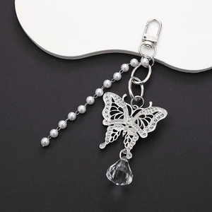Detail of silver butterfly keychain with sparkling rhinestones, crystal and pearl chain