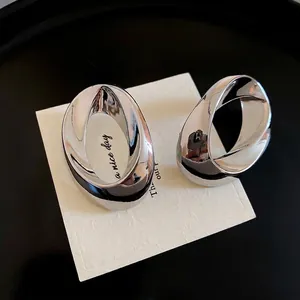 Polished silver oval twisted geometric stud earrings on a white card background