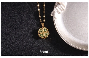 Front view of golden clover pendant necklace with green zircon inlay and textured metal edges