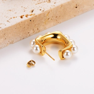 Vintage 18K gold plated square earrings with pearls on a decorative stone base