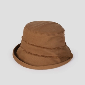 Detail of dark brown bucket hat with frayed raw edge fringe and cotton twill texture