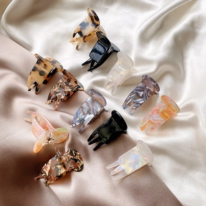 Set of 11 assorted acetic acid claw clips in marble and floral patterns on silk