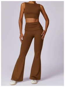 Detail of cross-waist design on high-waisted flare yoga pants in coffee brown color