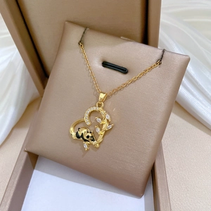 Detail of luxury heart pendant with panda and crystals in a champagne jewelry box