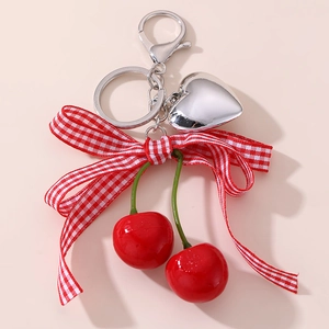 Cute cherry keychain with red berries, silver heart charm, and red checkered bow tie