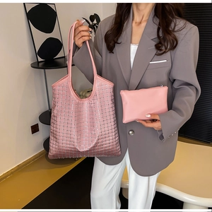 Pink rhinestone tote bag set with matching pouch shown in a modern interior setting