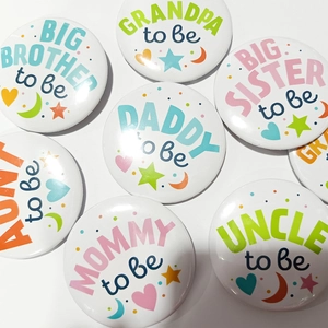 Set of colorful Baby Shower tinplate badges for family members like Mommy and Daddy to be