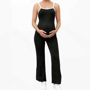 Close-up of maternity yoga jumpsuit with white contrast trim and supportive belly panel