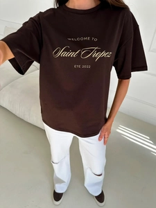 Detail of loose-fit dark brown cotton T-shirt featuring yellow Saint Tropez artistic print
