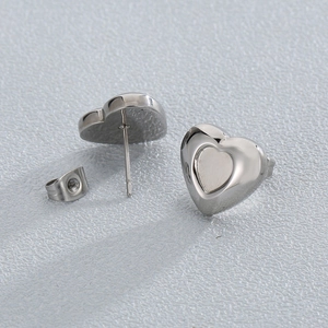 Detailed view of silver heart-shaped stud earrings showing front and back with secure backing
