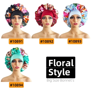 Detail view of large floral satin sleep bonnets in black, red, light blue and green patterns