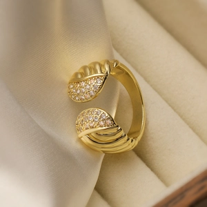 Elegant 18K gold plated leaf open ring with sparkling cubic zirconia on a satin background